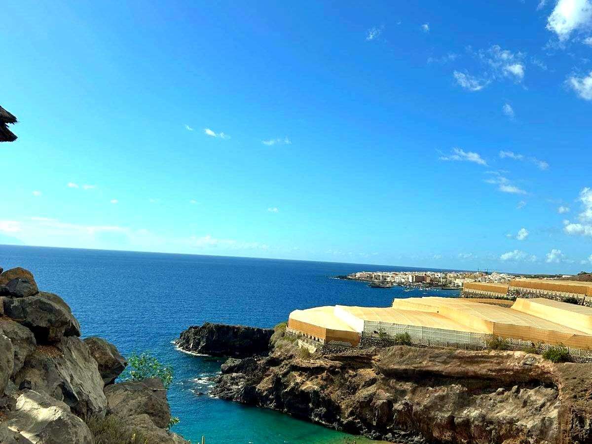 Turquoise water by the rocky shore near Golf del Sur